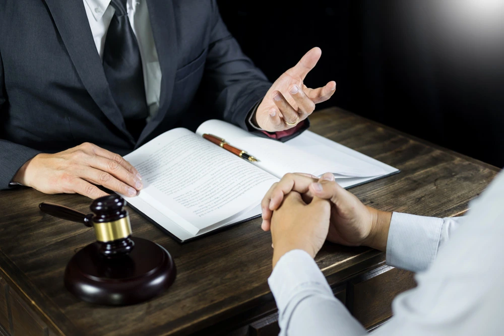 Lawyer or judge consult meeting with client at a law firm about legal legislation in courtroom with Judge gavel and Gold brass balance scale
